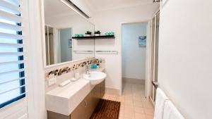 a bathroom with a sink and a mirror at Saltwater Stay in Bunbury +44 photos