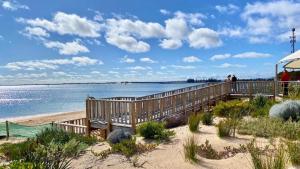 a boardwalk leading to the beach with people on it at Saltwater Stay in Bunbury