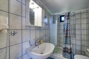 a bathroom with a sink and a toilet and a mirror at Analipsi Villas Beach Front in Kástro Tornéze +86 photos