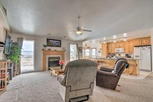a living room with two chairs and a kitchen at ATV Trail Access & Mtn Views! 2-Unit Group Retreat in Aurora