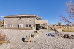 a house with a statue in front of a building at ATV Trail Access & Mtn Views! 2-Unit Group Retreat in Aurora