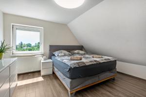 a bedroom with a bed and a window at Geräumiges Haus mit Garten Terasse in Nuremberg