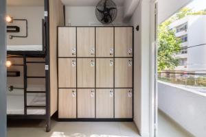 a locker room with lockers and a clock on the wall at Hostel Leblon in Rio de Janeiro