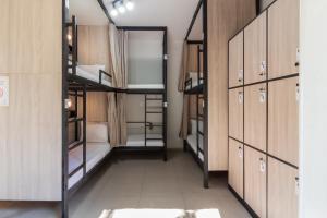 a room with bunk beds and cabinets and a hallway at Hostel Leblon in Rio de Janeiro