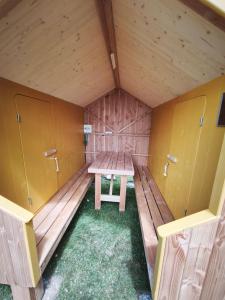 a small room with a picnic table in the middle at Camping Kerlaudy La pause Atypi'k in Plouénan