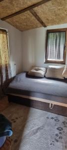 a large bed in a room with a window at Planinska kuca Gogo in Kupres