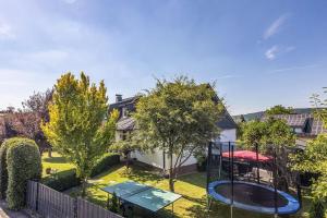 a backyard with a table and a trampoline at Ferienwohnung an der Bieke in Olsberg