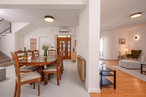 a dining room and living room with a table and chairs at Villa Botanica near Split - Heated Pool and Garden in Kučine