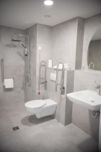 a bathroom with a sink and a toilet and a shower at Arche Hotel Lotnisko Gdańsk in Gdańsk-Rębiechowo +48 photos