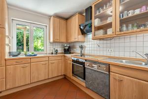 a kitchen with wooden cabinets and a sink at Geräumiges Haus mit Garten Terasse in Nuremberg
