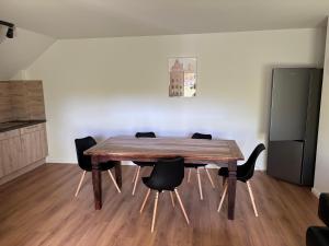 a dining room with a wooden table and chairs at Hochwertige Monteurunterkunft in Zarrentin +7 photos