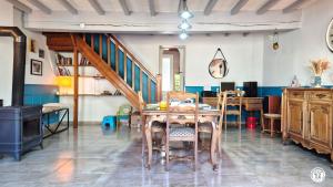 a dining room with a table and chairs and a staircase at Chez l'tiote morvandelle in Montigny-en-Morvan