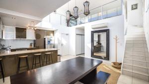 a kitchen with a large table and a large mirror at The Lookout in Woorim