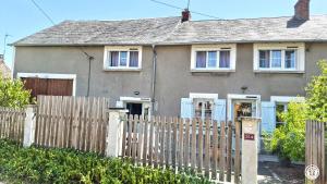 a house with a wooden fence in front of it at Chez l'tiote morvandelle in Montigny-en-Morvan +4 photos