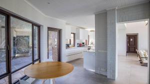 a kitchen with a wooden table in a room at Sunset Bay Stay in Hout Bay