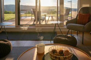 a room with a table with a bowl of fruit on it at 102 - Upscale Condo - River View Terrace in Baie-Saint-Paul