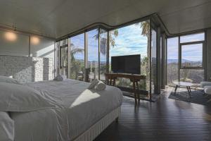 a bedroom with a bed and a flat screen tv at Villa Nola - Diseño Vasco, Lujo y Privacidad in San Sebastián +167 photos