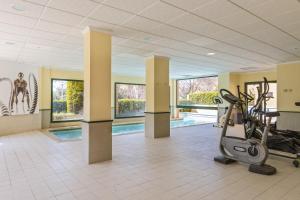 a fitness room with a gym with a treadmill at Floridamar Mimosa in Jávea