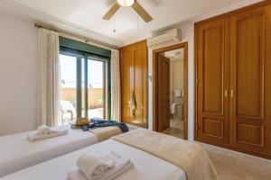 a bedroom with two beds and a window with a view at Floridamar Mimosa in Jávea +30 photos
