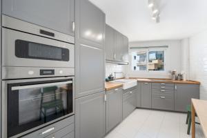 a kitchen with stainless steel appliances and a sink at Apartment Overlooking the Beach in Marbella