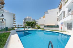 a swimming pool in the middle of a building at Apartment Overlooking the Beach in Marbella