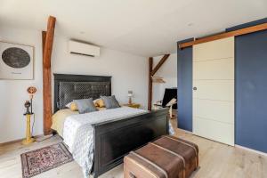 a bedroom with a large bed with a fireplace at La Grange in Reichstett