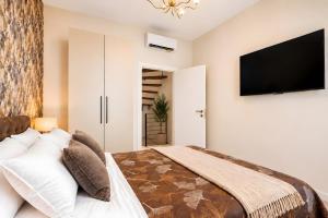 a bedroom with a bed and a flat screen tv at Dimora Camponobile - Turi in Turi