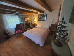 a bedroom with a bed and a tree in it at Braeschenberg in Breitenbach-Haut-Rhin
