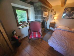 a bedroom with a bed and a chair and a fireplace at Braeschenberg in Breitenbach-Haut-Rhin +16 photos
