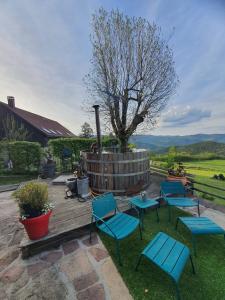 a group of chairs and tables on a wooden deck at Braeschenberg in Breitenbach-Haut-Rhin
