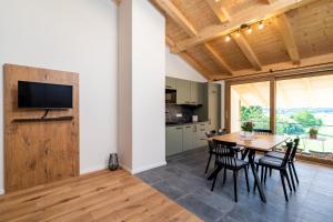 a kitchen and dining room with a table and chairs at Ferienwohnungen Schmiedhof in Eggstätt +30 photos