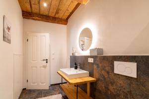 a bathroom with a sink and a mirror at Ferienwohnungen Schmiedhof in Eggstätt