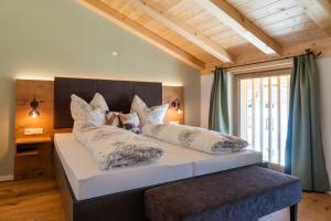a bedroom with a large white bed with pillows at Ferienwohnungen Schmiedhof in Eggstätt