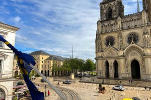 a cathedral with a large building with a clock tower at La Cathédrale - 47 m2 - 1 bedroom in Orléans