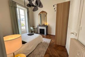 a bedroom with a bed and a mirror and a table at La Cathédrale - 47 m2 - 1 bedroom in Orléans