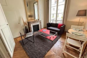 a living room with a couch and a fireplace at La Cathédrale - 47 m2 - 1 bedroom in Orléans