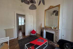 a living room with a fireplace and a mirror at La Cathédrale - 47 m2 - 1 bedroom in Orléans