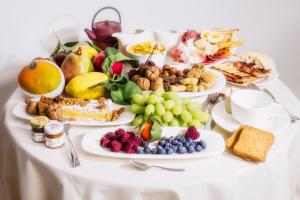 a table with many plates of food on it at Locanda Black and White Sondrio in Sondrio