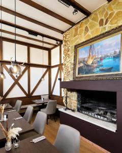 a restaurant with a fireplace and tables and chairs at Hotel Weinhaus Wiedemann in Ginsheim