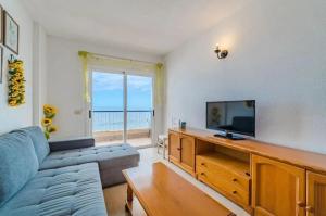 a living room with a couch and a flat screen tv at oceano de bajamar in Bajamar