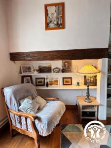 a living room with a chair and a table at La Chambre des Tours in Biran