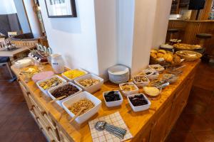 a buffet of food on a wooden table at Papagenoblick in Filzmoos +17 photos