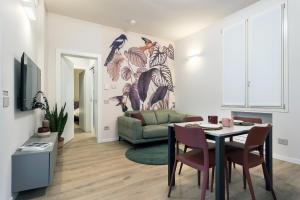 a living room with a table and a couch at GuestHost - Vivaldi Autunno Apartment in Treviglio