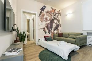 a living room with a bed and a couch at GuestHost - Vivaldi Autunno Apartment in Treviglio