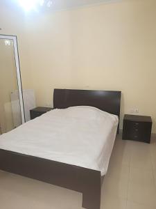 a bedroom with a bed and two night stands at Gialova Relax in Korifásion