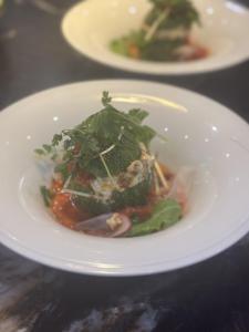 a white plate of food on a table at La Villa des Cedres in Bonnieux