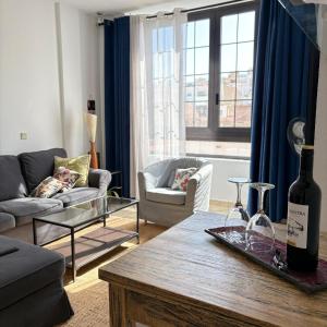 a living room with a bottle of wine on a table at Apartamento playero Privado WiFi- MorroJable in Morro del Jable