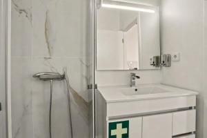 a bathroom with a sink and a shower with a mirror at Casa Albano 3 in Caldas da Rainha +16 photos