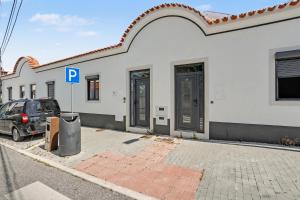a car parked in front of a building with a parking meter at Casa Albano 3 in Caldas da Rainha