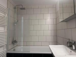 a bathroom with a shower and a sink and a tub at NEU! Kleines Glück Illingen in Illingen +7 photos